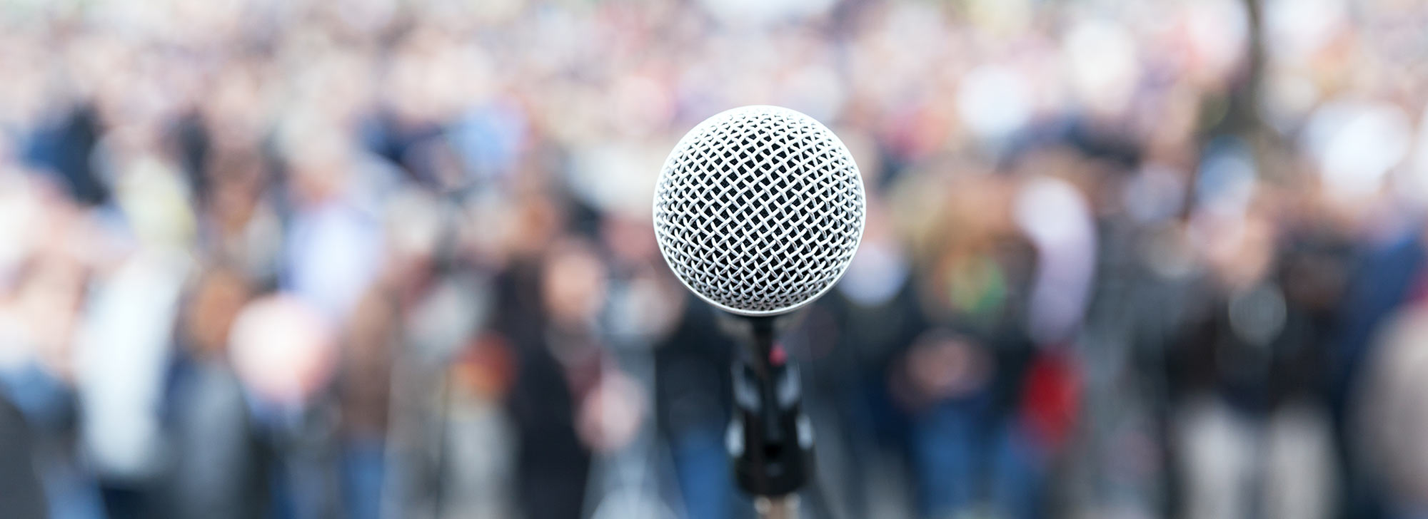A microphone in front of a crowd of people
