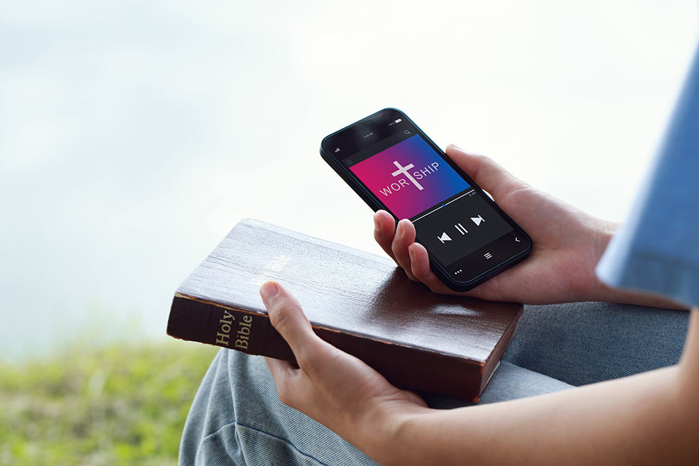 A congregant plays an audio clip of a church sermon on their phone.